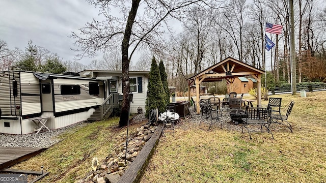 view of yard with a gazebo and a fire pit