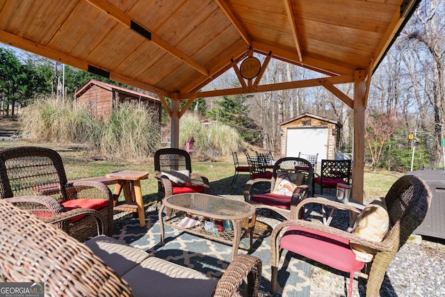 view of patio / terrace with an outdoor structure and a shed