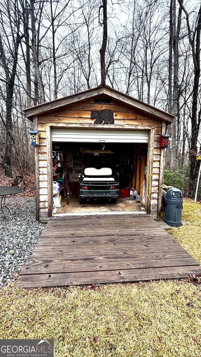 exterior space featuring an outdoor structure, concrete driveway, and a garage
