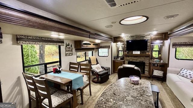 living area featuring a stone fireplace