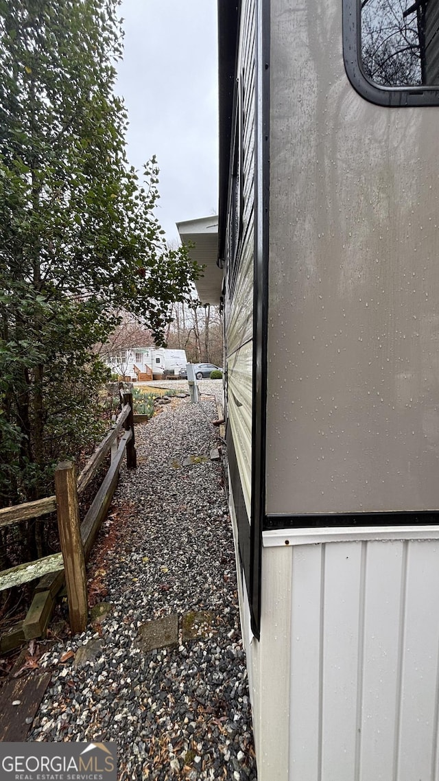 view of side of home featuring fence