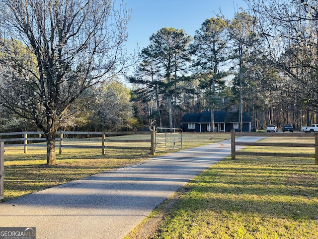 view of road featuring aphalt driveway and a gated entry