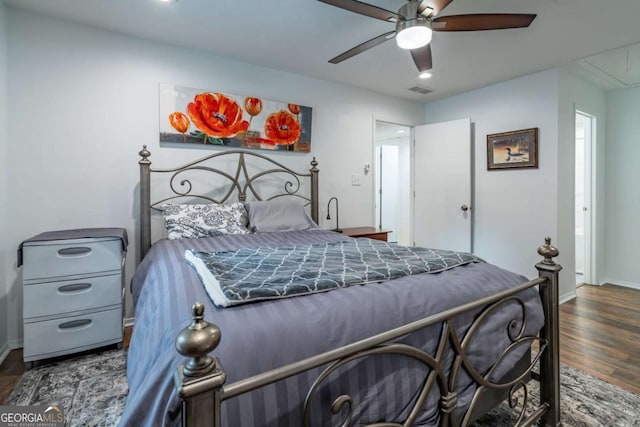 bedroom with attic access, wood finished floors, baseboards, and ceiling fan