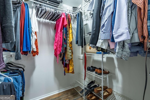 spacious closet with wood finished floors