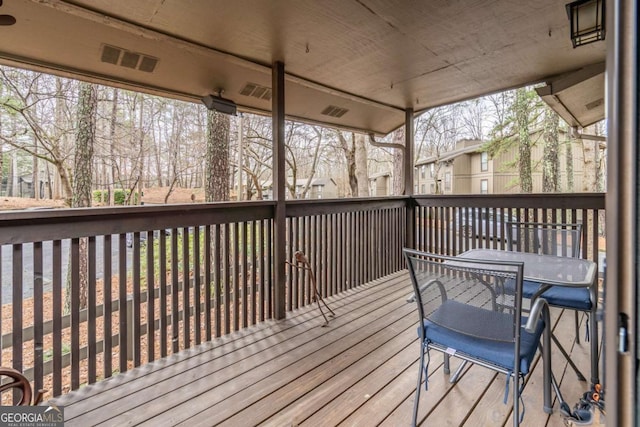 wooden terrace with outdoor dining space