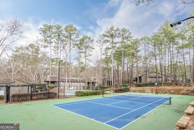 view of sport court with fence