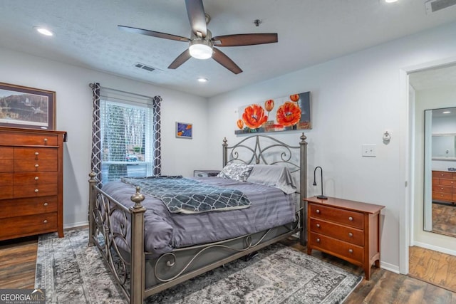 bedroom featuring visible vents, baseboards, and wood finished floors