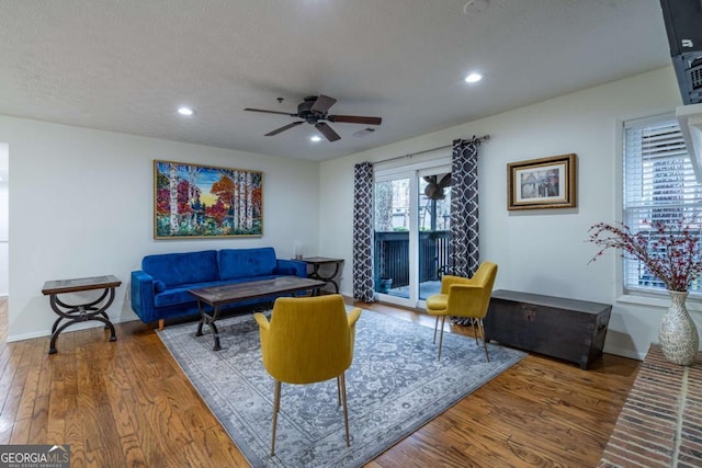 living room with recessed lighting, baseboards, and wood finished floors