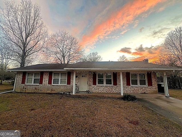 single story home featuring covered porch and a chimney