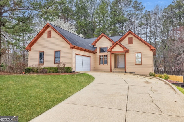 view of front of home with an attached garage, concrete driveway, and a front lawn