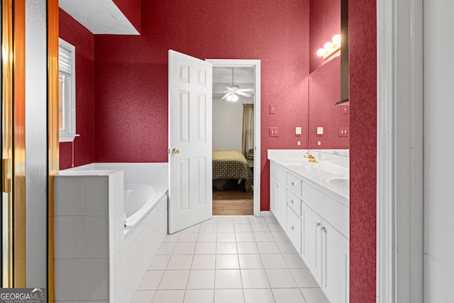 ensuite bathroom featuring tile patterned floors, a garden tub, ensuite bathroom, double vanity, and a textured wall