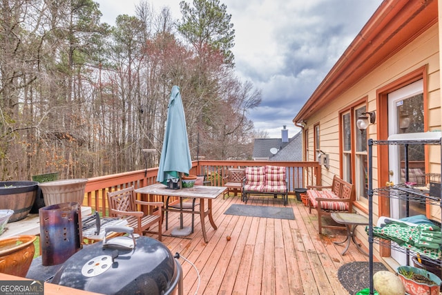 wooden deck with an outdoor living space and outdoor dining area