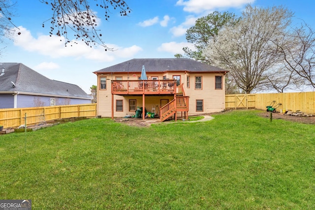 back of property featuring a lawn, a wooden deck, stairs, and a fenced backyard