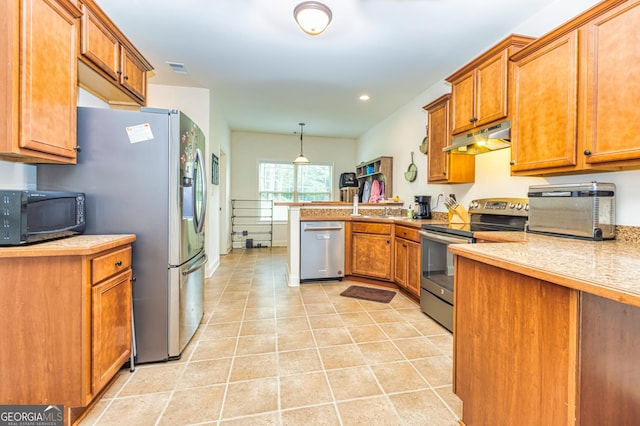kitchen featuring appliances with stainless steel finishes, brown cabinetry, under cabinet range hood, and a peninsula