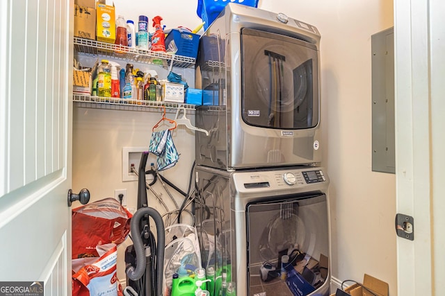 laundry area featuring laundry area, stacked washer and dryer, and electric panel