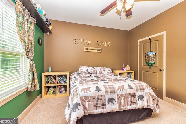 bedroom with carpet floors, a ceiling fan, and baseboards
