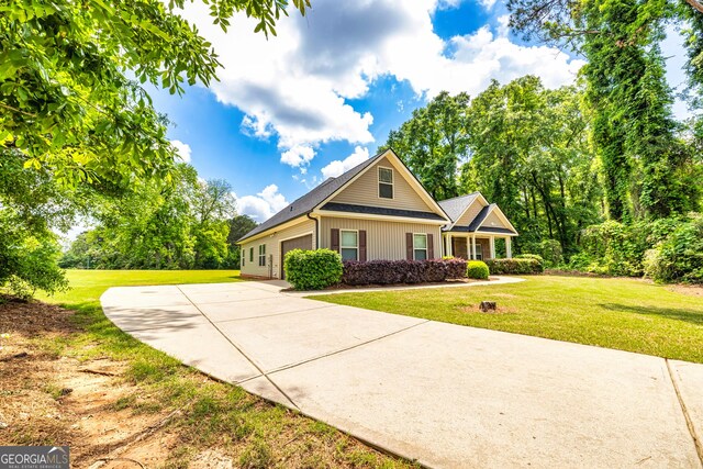 view of front of home featuring a garage, driveway, and a front lawn
