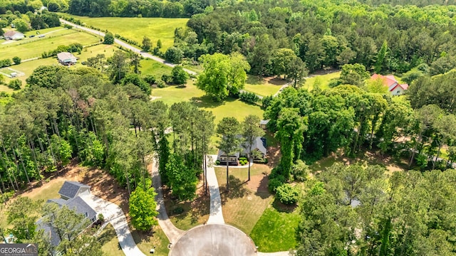birds eye view of property with a forest view