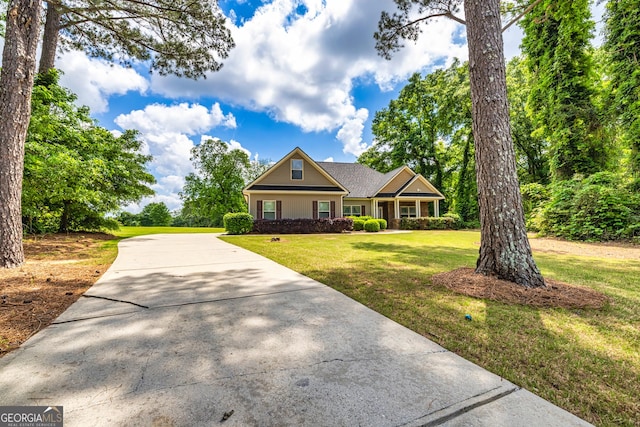 craftsman house with driveway and a front lawn