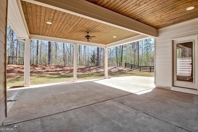 view of patio with ceiling fan and fence