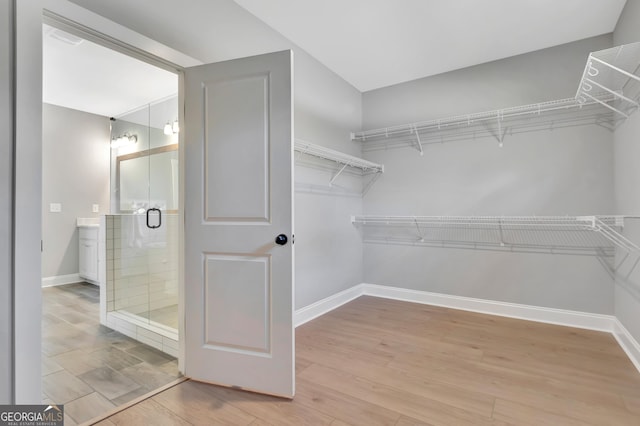 spacious closet with light wood-style floors