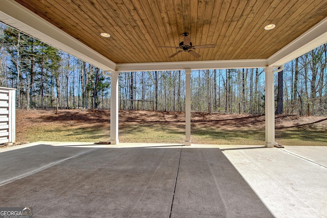 exterior space with ceiling fan and fence