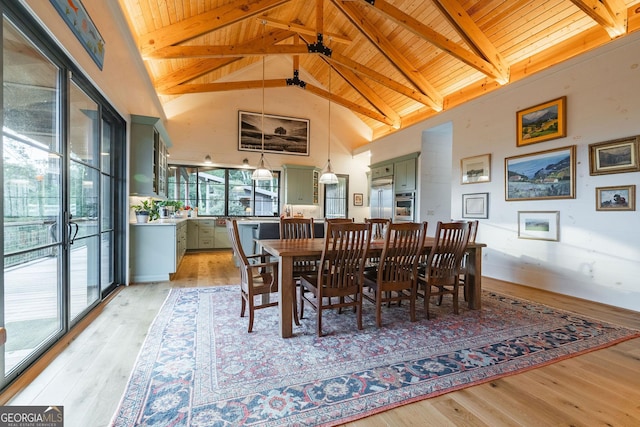 dining space with beam ceiling, wooden ceiling, and light wood finished floors