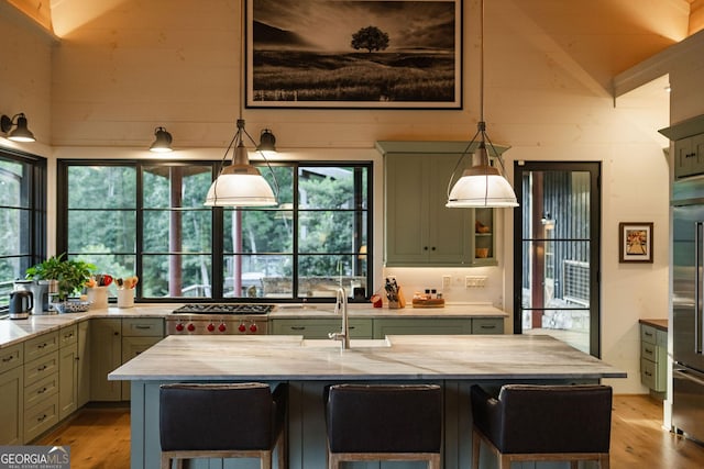 kitchen with a breakfast bar, light wood-style flooring, range, and light stone countertops