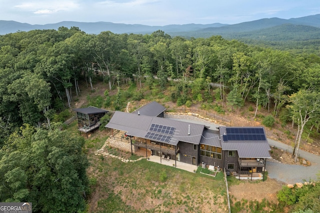 bird's eye view featuring a mountain view and a view of trees