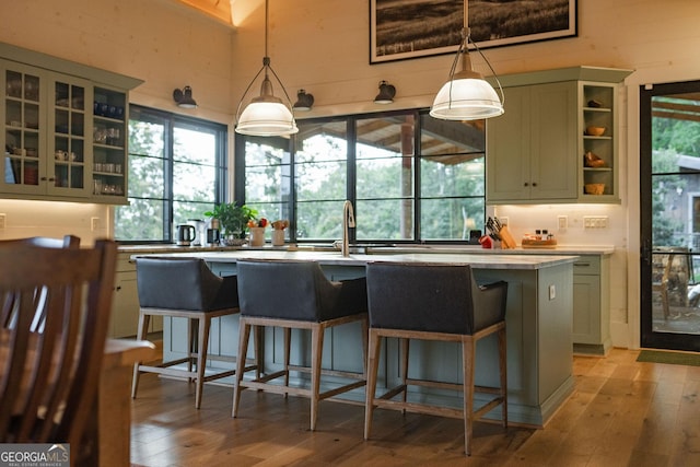 kitchen with a kitchen bar, light wood-type flooring, and a wealth of natural light