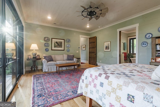 bedroom featuring wood finished floors, visible vents, baseboards, crown molding, and wooden ceiling