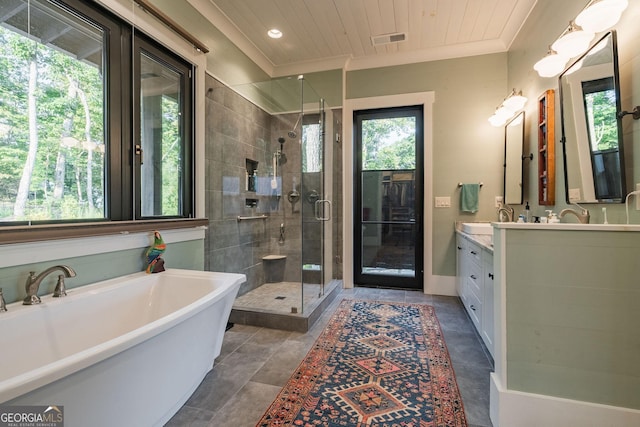 full bath with visible vents, a shower stall, crown molding, a soaking tub, and vanity