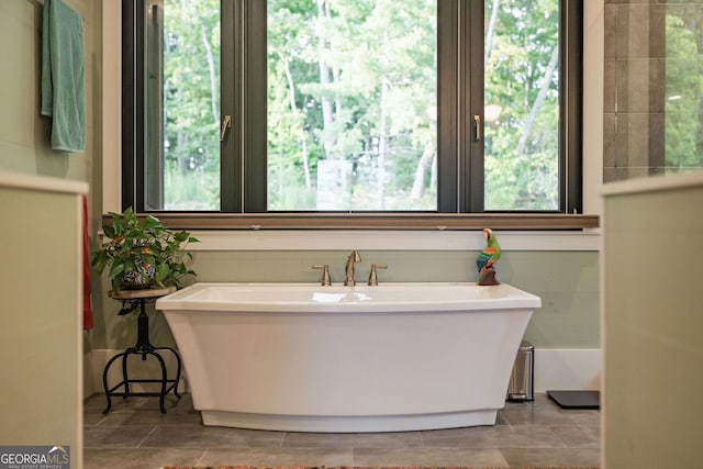 full bathroom with plenty of natural light and a soaking tub