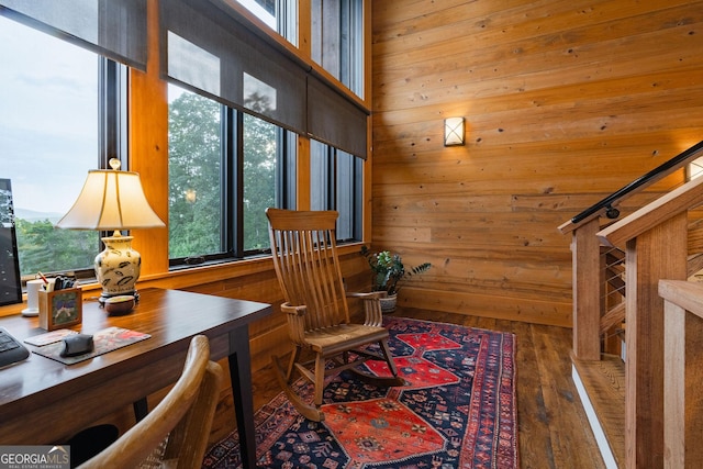 office area featuring wooden walls and wood finished floors