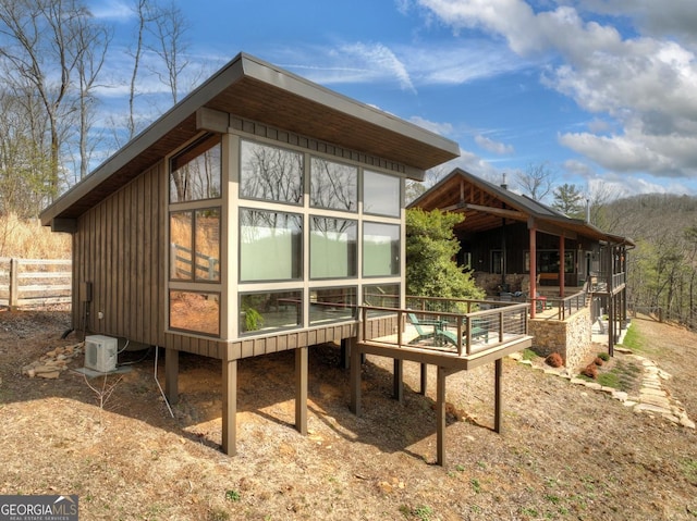 rear view of property with ac unit