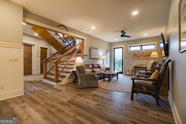 living room featuring wood finished floors, recessed lighting, stairway, baseboards, and ceiling fan