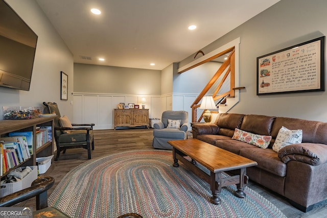 living room featuring recessed lighting, stairs, wood finished floors, and wainscoting