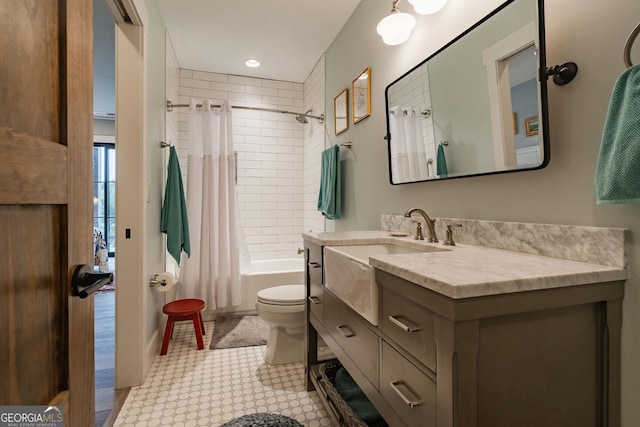 bathroom featuring vanity, shower / tub combo, and toilet