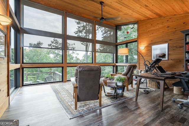 sunroom with a healthy amount of sunlight, wooden ceiling, and a ceiling fan