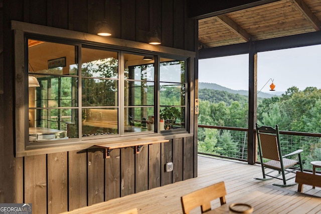 sunroom featuring a wooded view