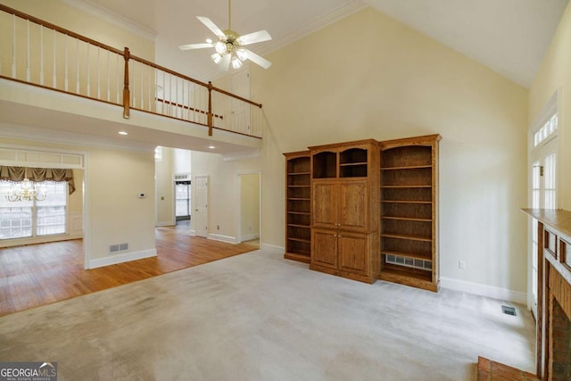 unfurnished living room with baseboards, visible vents, and ornamental molding