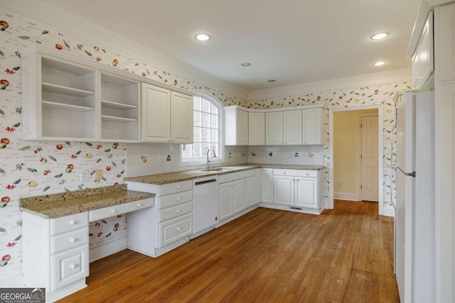 kitchen featuring white appliances, wood finished floors, open shelves, ornamental molding, and a sink