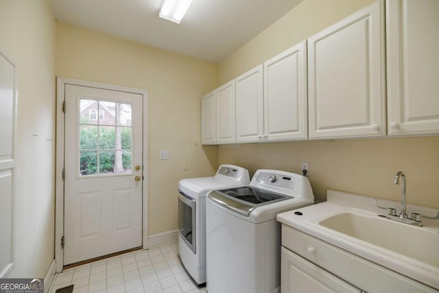 laundry room with light tile patterned floors, baseboards, cabinet space, a sink, and washer and dryer