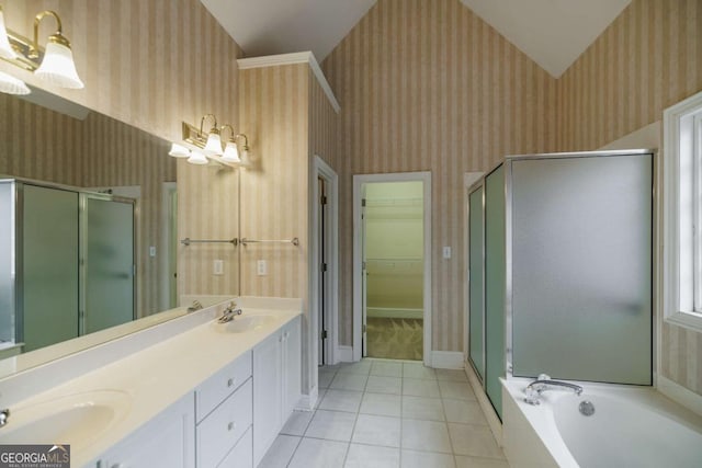 bathroom with wallpapered walls, a shower stall, and a sink