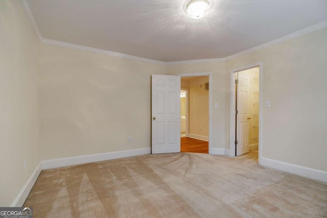 carpeted empty room with baseboards and ornamental molding