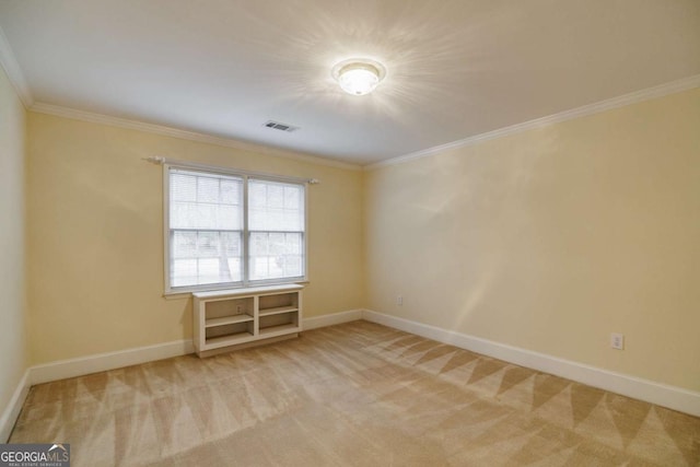 spare room featuring visible vents, light carpet, baseboards, and crown molding