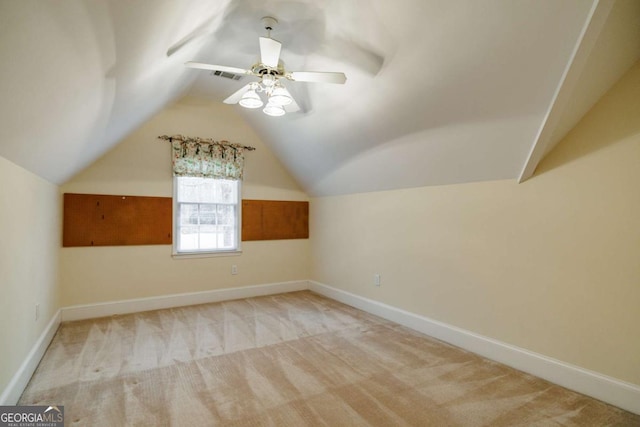 bonus room with visible vents, light carpet, baseboards, and vaulted ceiling