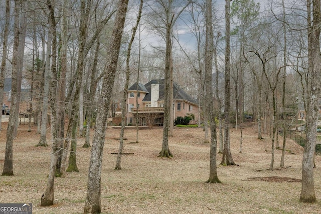 view of front of house with a deck and brick siding