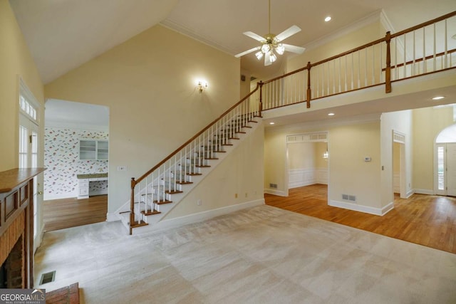 interior space with a wealth of natural light, baseboards, a high ceiling, and carpet