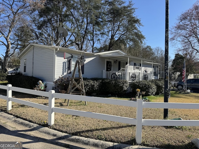 view of front of house featuring a fenced front yard and covered porch